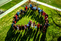 Big group family picture from above in the shape of a heart.