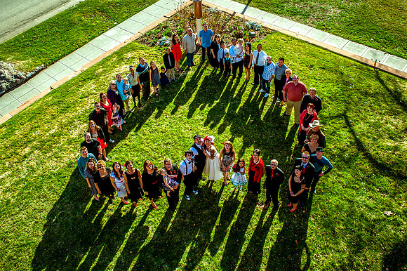 Big group family picture from above in the shape of a heart.