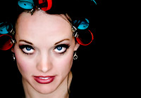 Bride getting ready with blue and red curlers in her hair