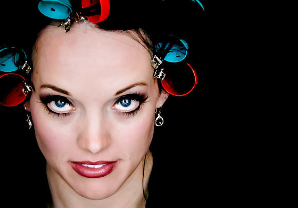 Bride getting ready with blue and red curlers in her hair