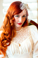 Vintage bride with beautiful red hair in front of back lit wooden blinds