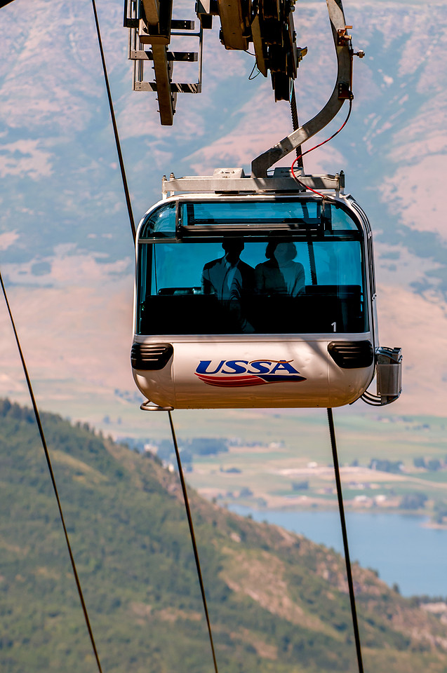 Bride and groom ride gondola to their ceremony in the needles lodge, Snowbasin, Utah