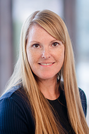 A cinematic shot of Stephanie Morgan, a real estate professional, standing elegantly in a beautifully renovated home, captured by Brian Smyer and Smyer Image