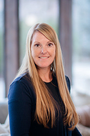 A cinematic shot of Stephanie Morgan, a real estate professional, standing elegantly in a beautifully renovated home, captured by Brian Smyer and Smyer Image