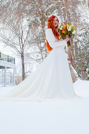 Stunning red hair on a fair skinned bride in the snow at the Woods on Ninth, Utah