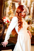 Red head 40's bride posing with big chair in front of painting