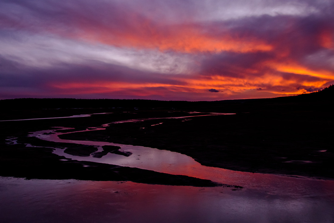 Captivating Yellowstone: A Serene River Embracing a Majestic Sunset