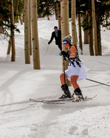 Bride and groom skiing in the trees