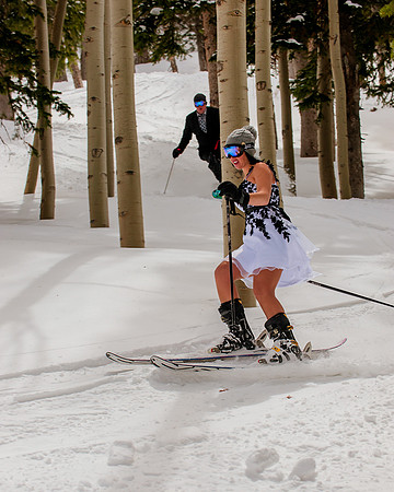 Bride and groom skiing in the trees