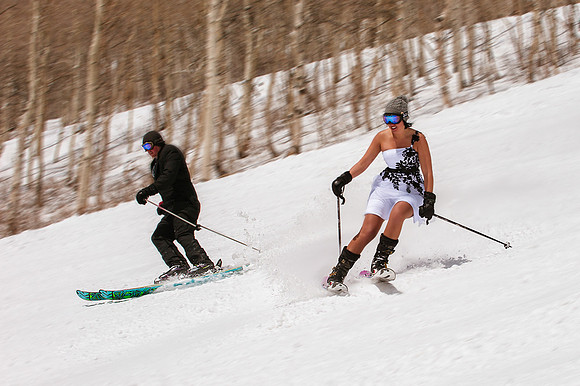 Bride and groom making turns on skis