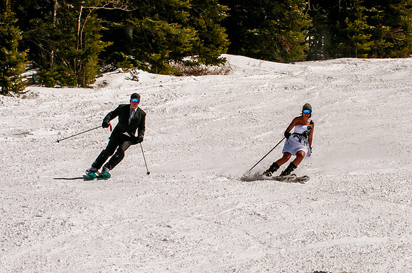 Bride and groom skiing in wedding dress and suit