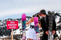 Bride and groom kiss on top of the world