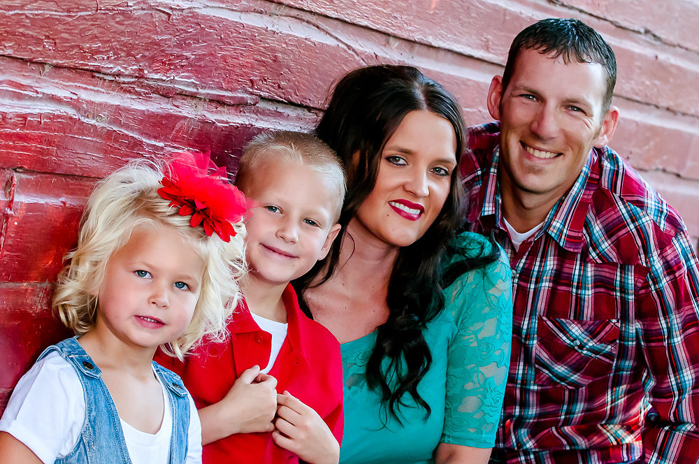 Family portrait against red barn