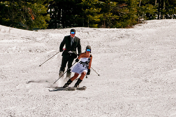 Bride and groom ski together