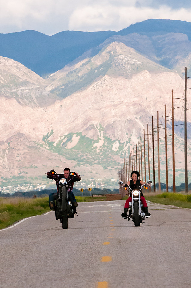 Groom rides a wheely on Harley motorcycle