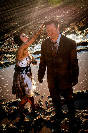 Bride dumps handful of mud on groom's head