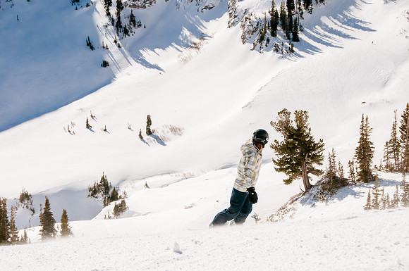 Veteran snowboarding into Mineral Basin, Snowbird