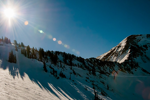 Sun flare over mountain top.  Snowbird, Utah