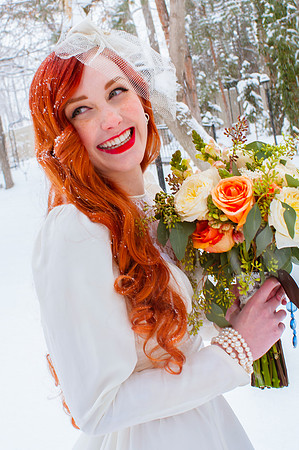 Vintage red head bride in the snow with a beautiful bouquet from Studio Stems
