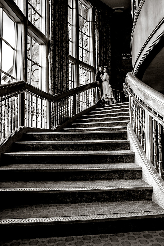 Snowbasin Wedding Inspiration-Bride and groom pose on beautiful staircase.