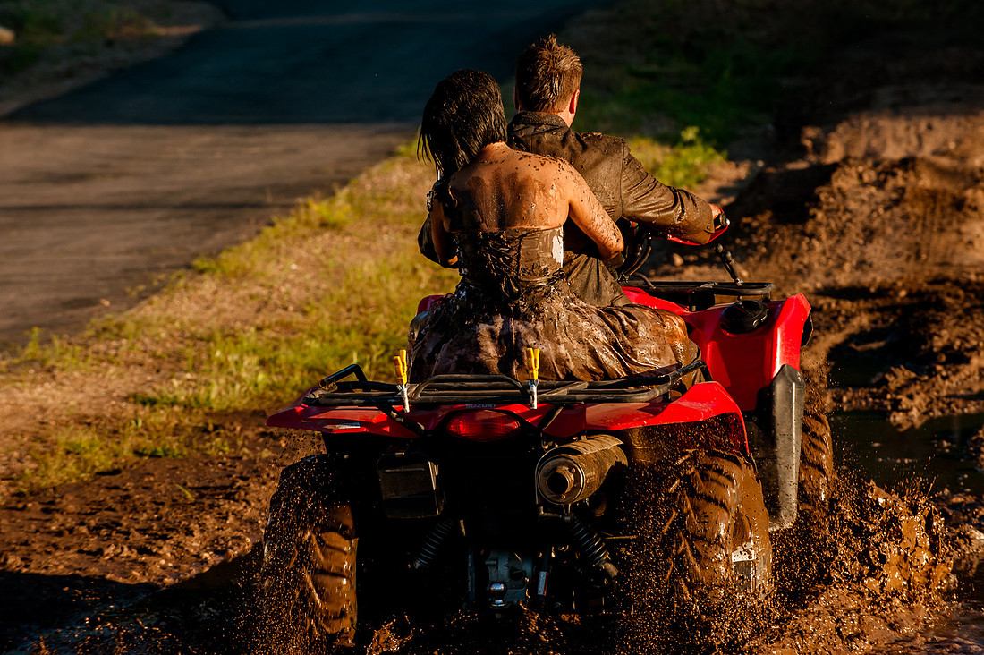 Muddy wedding dress on an atv