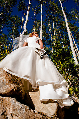 Bride carrying heels poses with the aspens at Deer Valley, Park City, Utah