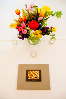 Floral arrangement with candles and book