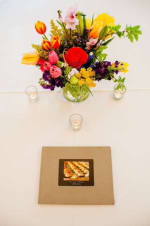 Floral arrangement with candles and book