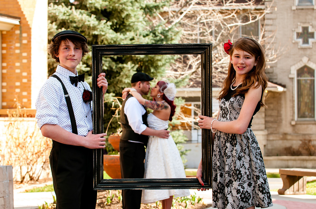 Kids framing Mom and Dad kissing.