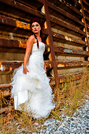 Red haired bride with white wedding dress waiting for a train