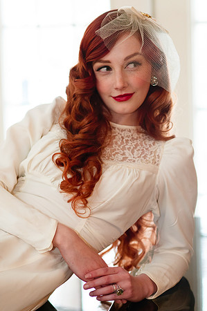 Vintage red head bride on a piano back lit with natural window light.