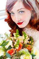 Stunning bride with red hair, veil, red lips, and floral bouquet from Studio Stems