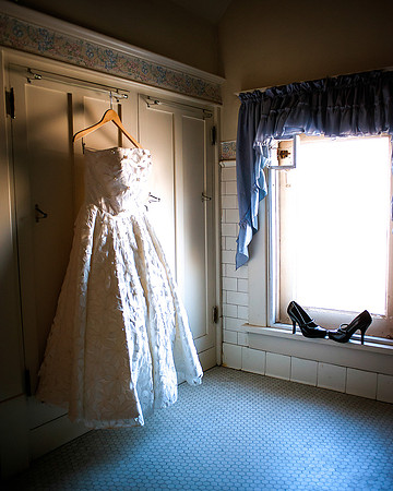 Vintage wedding dress shot in antique bathroom, high heels included.