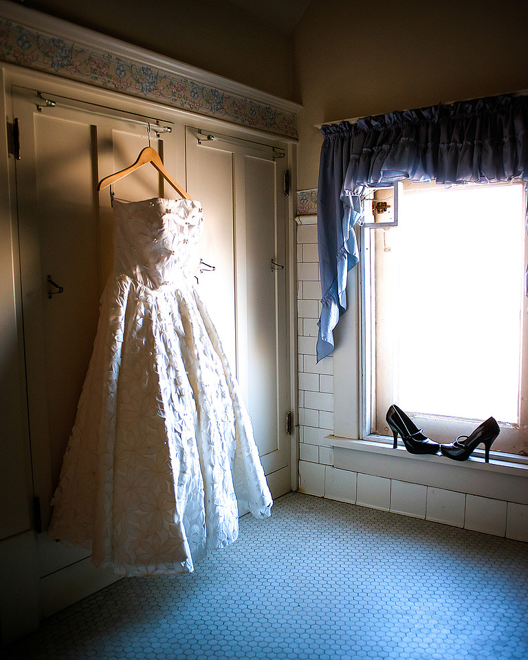 Vintage wedding dress shot in antique bathroom, high heels included.