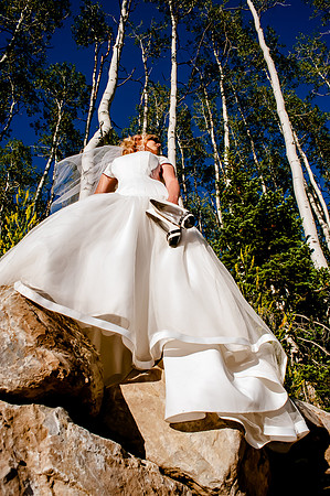 Bride carrying heels poses with the aspens at Deer Valley, Park City, Utah