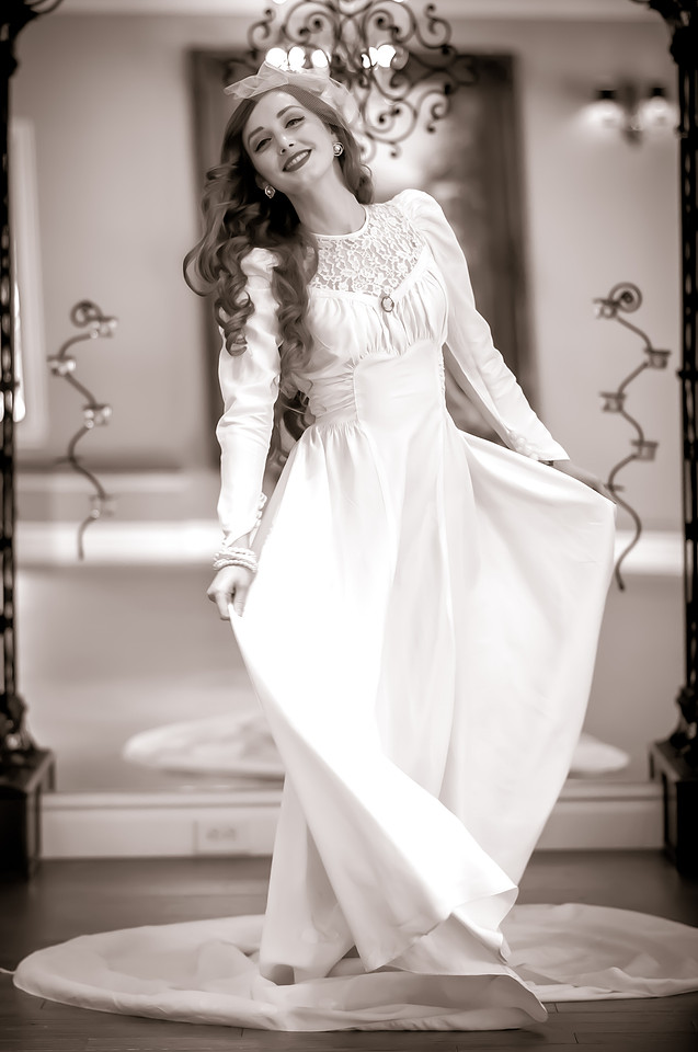 Black and white 40's inspired bride twirling her wedding dress in front of a mirror at the Woods on Ninth, Utah