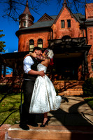 Tattooed bride and groom kiss in front of Eccles Art Center in Odgen, Utah